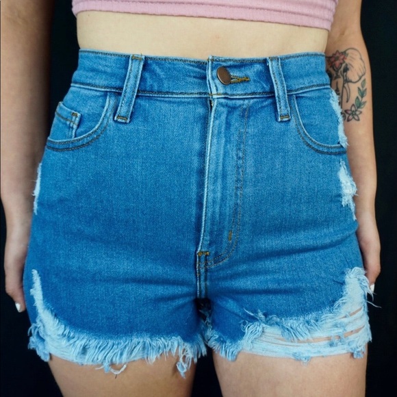 Medium wash stretch denim shorts with distressing detail - Picture 2 of 4